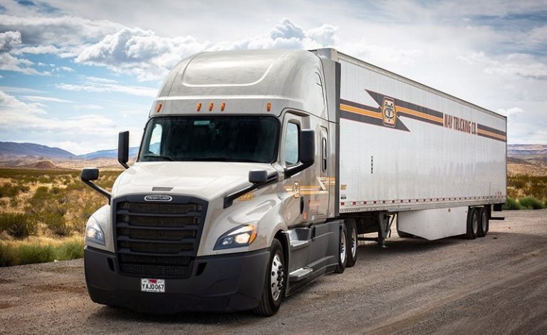 May Trucking Company Freightliner semi-truck on a desert highway
