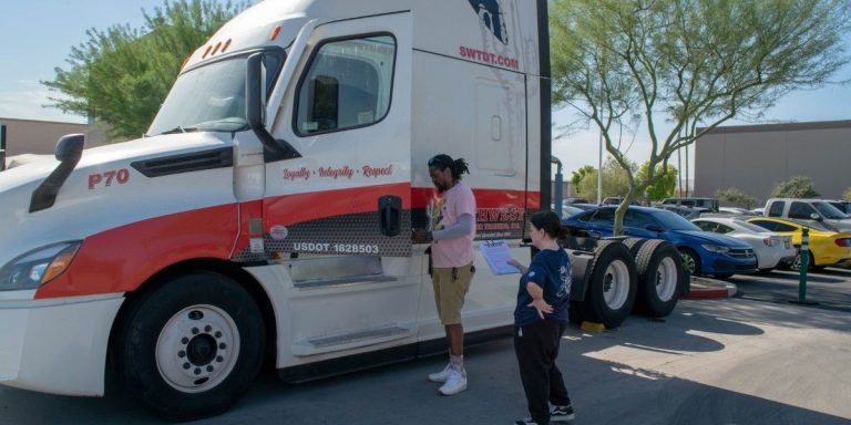 Two CDL students reviewing pre-trip inspection paperwork beside a Southwest Truck Driver Training semi-truck during ELDT-compliant yard training