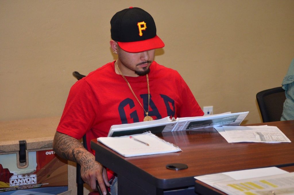CDL student studying the Arizona Commercial Driver License manual to prepare for the CDL knowledge test