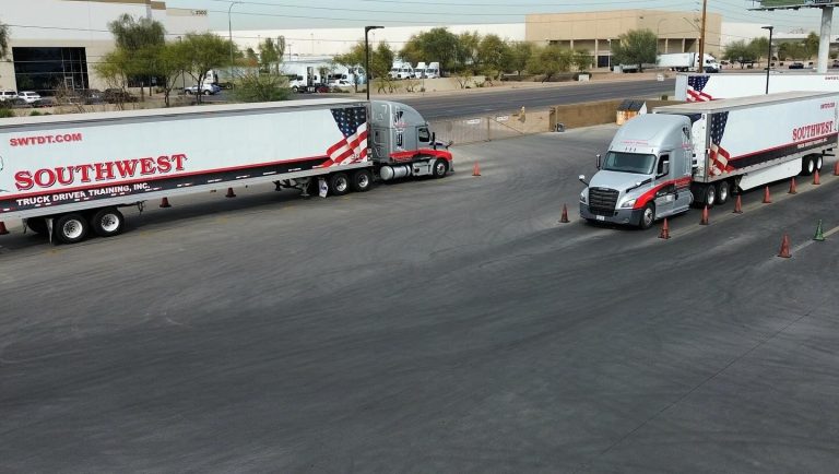 Aerial view of Southwest Truck Driver Training student drivers practicing backing maneuvers with semi-trucks in the Phoenix training yard