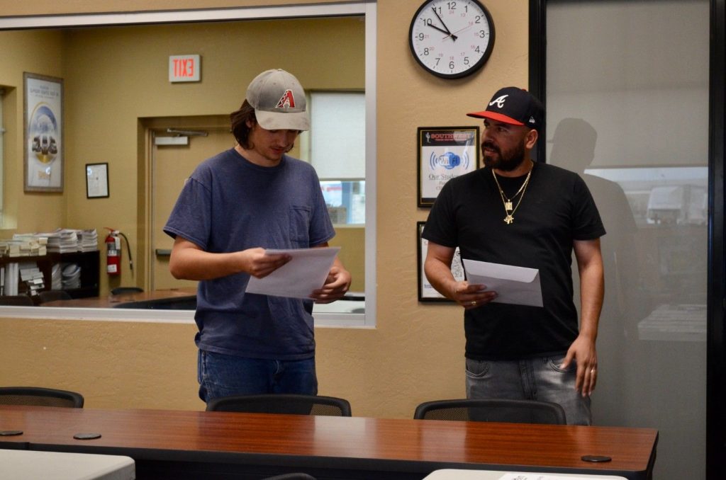 Two CDL students reviewing paperwork in a Southwest Truck Driver Training classroom or office