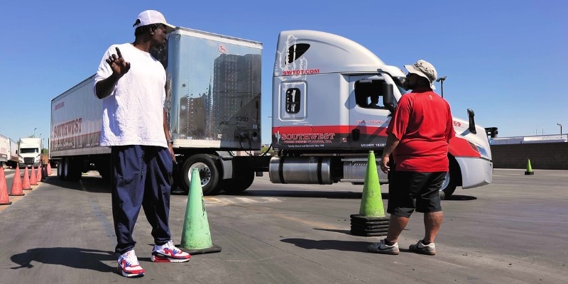 CDL student and instructor working together on backing maneuvers with training cones at Southwest Truck Driver Training
