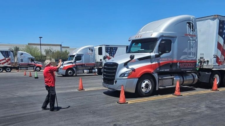 CDL instructor in a red shirt directing a student driver through a cone course at Southwest Truck Driver Training