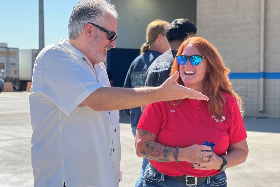 Steve Strong, VP of Administration of Southwest Truck Driver Training, shares a laugh with Gina Jones, Southwest Truck Driver Training graduate and current Werner Enterprises driver