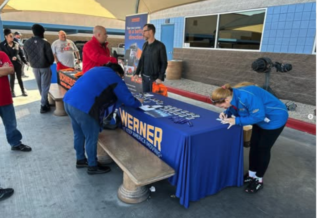 Open house attendees talk with Werner hiring representatives