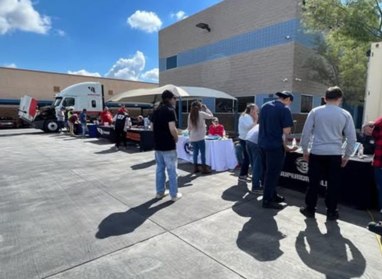 CDL graduates and trucking company recruiters networking at an outdoor job fair at Southwest Truck Driver Training
