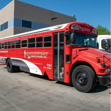 Southwest Truck Driver Training red bus parked in concrete training yard