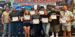 Large group of graduates holding Certificate of Course Completion at Phoenix campus