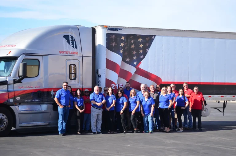 Group of SWTDT team posed in front of semi truck