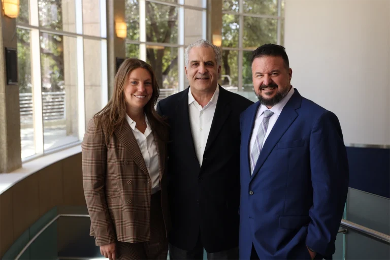 Sean, Samantha, and Bruce smiling together at PTDI summit